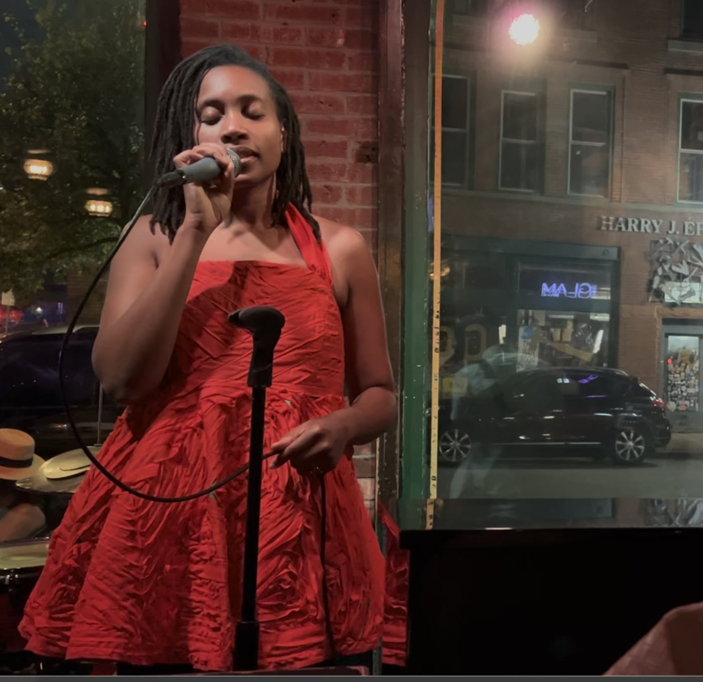 Rachel performing in a red custom-made dress